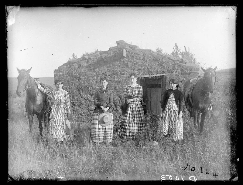The four Chrisman sisters on horseback before a sod dwelling on their Custer County homestead claims