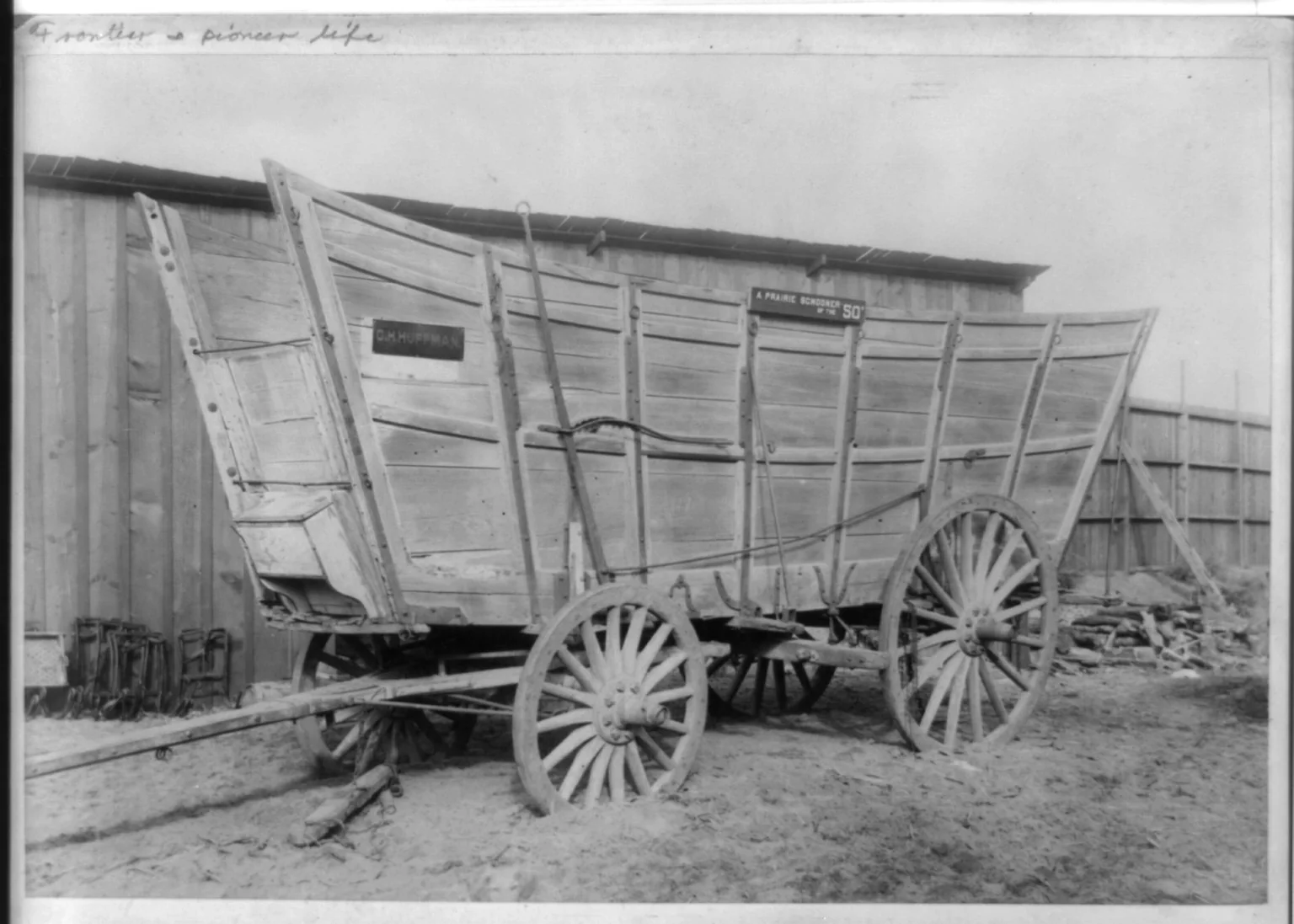 A real historic photograph of a canvas-topped prairie schooner covered wagon of the type used by 1850s overland emigrants