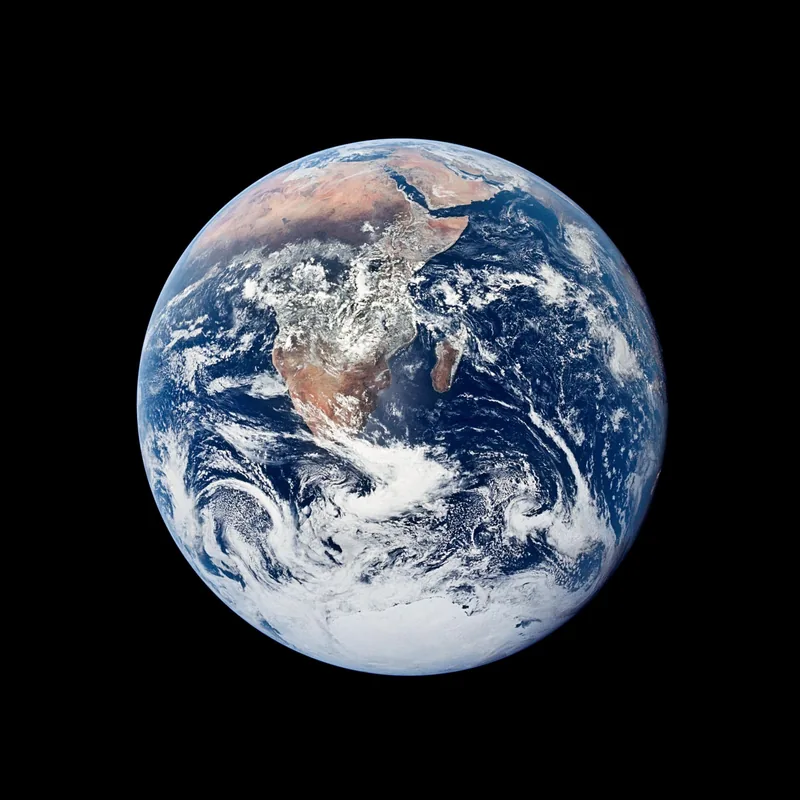 The whole Earth seen from space: Africa, the Arabian Peninsula and the Antarctic ice cap under swirling white clouds